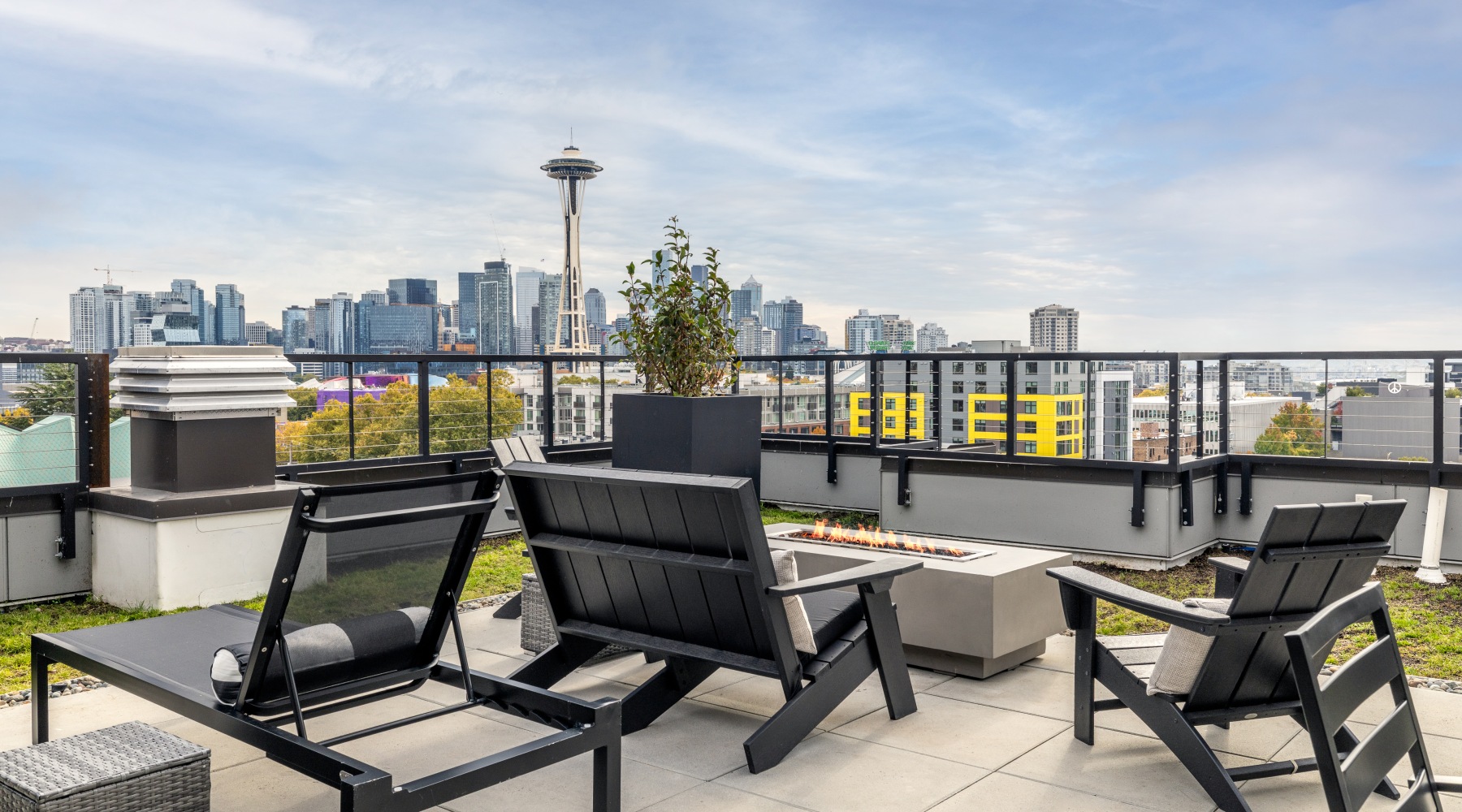 Chairs in from of firepit with Seattle skyline in background